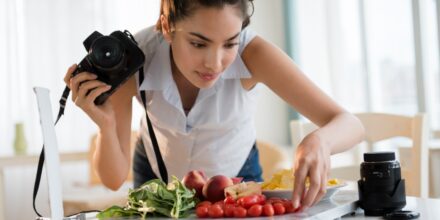Hispanic woman photographing food